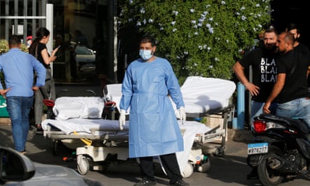 A man with medical equipment waits outside hospital