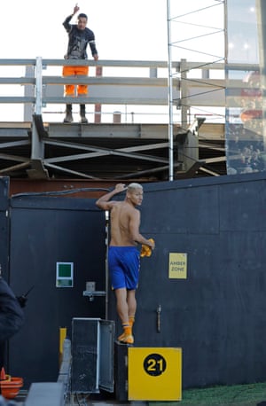 Richarlison gives his shirt to a builder working on the new stand after Fulham v Everton on 22 November.