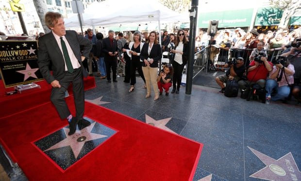 Actor Laurie poses on his star after it was unveiled on the Hollywood Walk of Fame.