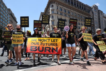 people hold signs calling attention to climate change