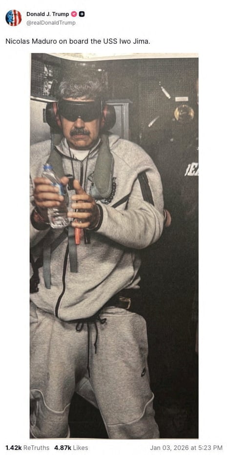 Nicolás Maduro blindfolded, wearing ear defenders and with what looks like his hands bound, wearing a grey tracksuit