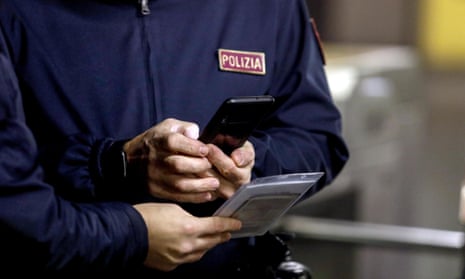 Close-up of hand of police in Italy with smartphone