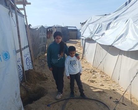 The children near white tents