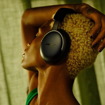 person with black headphones looks to side