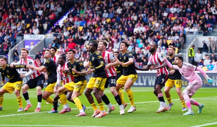All eyes are on the ball as a Brentford long throw is launched into the Manchester United penalty area