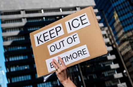 closeup of a hand holding a sign that reads ‘keep ice out of Baltimore’
