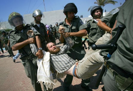 five soldiers carry a young man