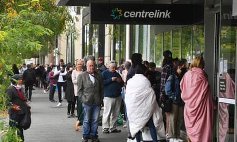 People queue outside an Australian government welfare centre, Centrelink, in Melbourne on 23 March 2020