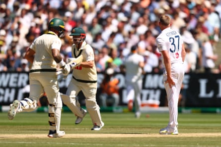 Gus Atkinson holds his left leg after a bowling during day two of the fourth Ashes Test