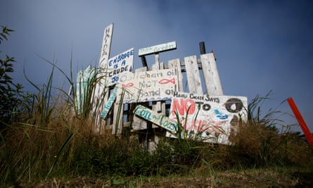 Anti-pipeline signs are seen on the side of a road in the First Nations village of Old Massett, British Columbia.