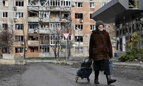 A woman walks in front of a heavily damaged residential building in the frontline town of Avdiivka, Donetsk region, this week