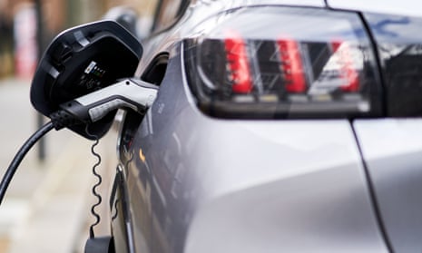 A Peugeot electric car plugged into a EV charging point
