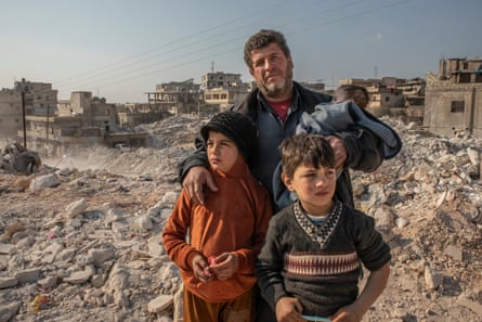 Mohammed Hadi with his two children and his baby daughter, who survived at the earthquake.