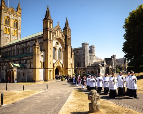 Clergy process past Buckfast Abbey during Ann Widdecombe's funeral procession