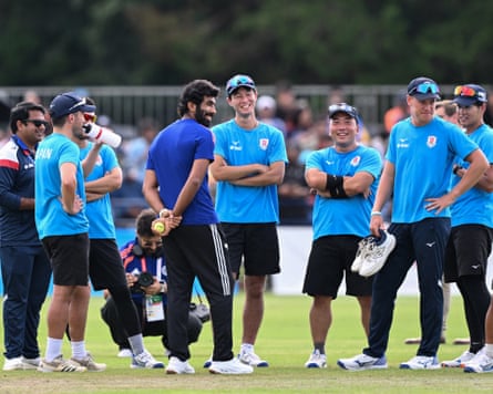 A smiling Jasprit Bumrah speaks with Japanese players