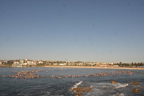 A ring of surfers and swimmers is formed as a tribute during a paddle out.