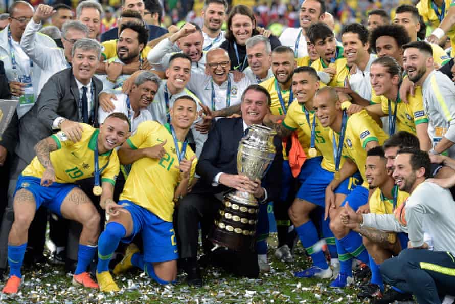 Jair Bolsonaro holds the Copa América trophy in 2019.