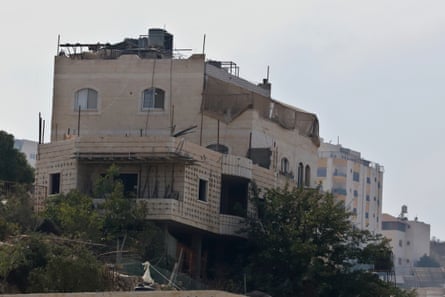 Fahed Ahmaro’s house in Hebron, now a military position, with netting over its upper floors