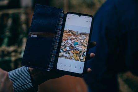 A phone with pictures of destroyed buildings