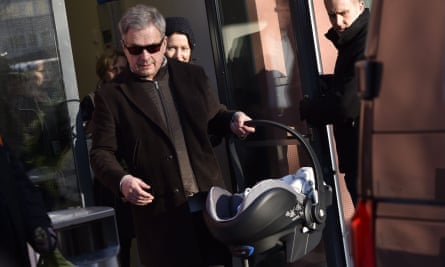Finnish President Sauli Niinistö and spouse Jenni Haukio leave hospital with their new baby boy in Helsinki