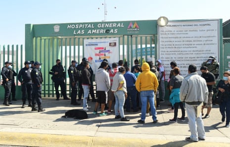Relatives of coronavirus patients await information about loved ones outside Las Americas hospital, where at least twenty people broke in to confront medical personnel over a lack of information.