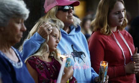People attend a vigil for victims of the mass shooting at the Gilroy garlic festival.