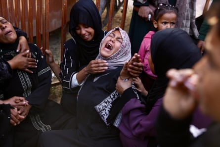 People mourn at a funeral