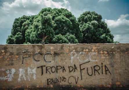 An old brown brick wall featuring graffiti
