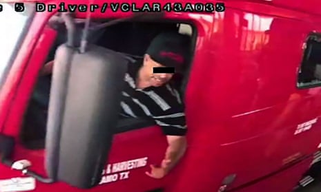 This handout picture released by Mexico's National Migration Institute (INM) shows truck driver identified by Mexican immigration officials as ‘Homero N’ allegedly carrying dozens of migrants, driving through a security checkpoint in this surveillance photograph in Laredo, Texas, on 20 June.