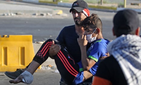 Protester carries a wounded man
