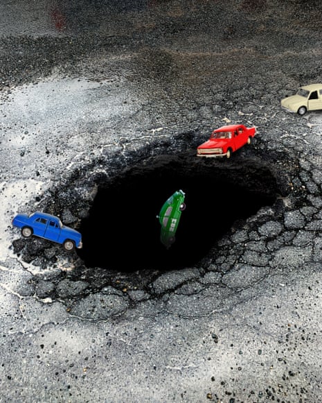 Graphic illustration of toy cars positioned around a large pothole in damaged asphalt, with one green car tipping into it