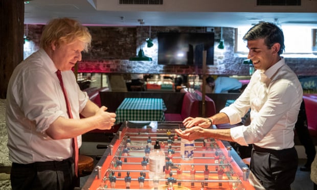 Boris Johnson and Sunak use hand sanitiser during a visit to a restaurant in east London as business prepared to reopen following a Covid lockdown in June 2020.