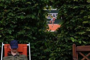 A spectator takes a nap next to the court