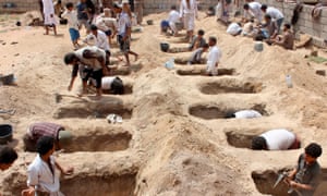 Yemenis dig graves for children killed when their bus was hit during a Saudi-led coalition airstrike in Sa’ada.