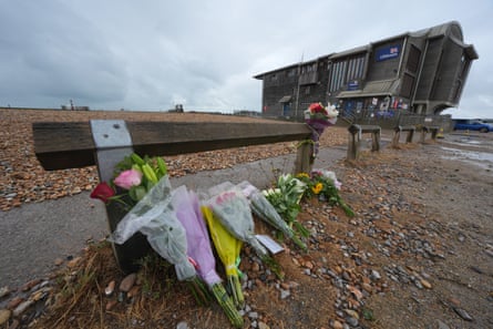 Floral tributes on the beach at Shoreham-by-Sea, near the RNLI station.