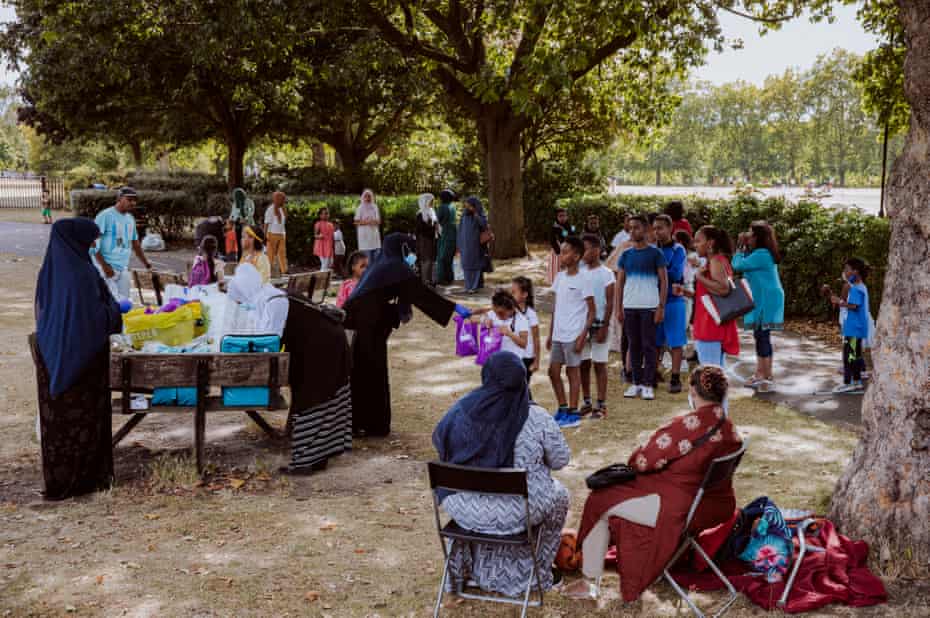 Shukri Adan and her volunteers hand out meals and bags of gifts to children in a park