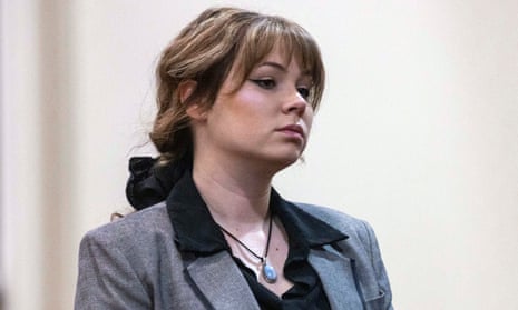 a woman in a grey suit stands in court