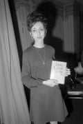 She stands holding her book