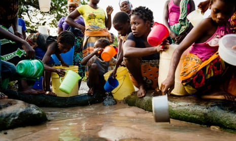 Women and children gather to collect water from a water source in Mossuril district in Mozambique. Almost half of the country’s 26 million population don’t have access to safe water