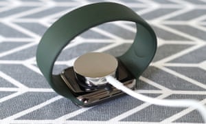 A picture of charging puck clips to the back of the watch via magnets.