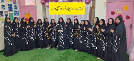 A semi circle of women wearing black chadors.