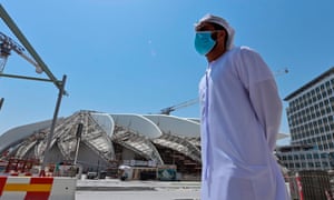 An Emirati man stands outsite the Dubai Expo 2020 site, under construction in the Emirati city, on June 14, 2020.