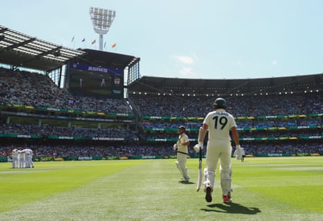 Scott Boland and Travis Head walk out to bat on day two of the fourth Ashes Test at the MCG