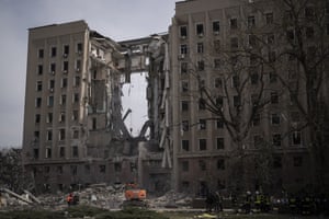 Emergency personnel work at the site of the regional government headquarters of Mykolaiv, Ukraine, following a deadly Russian attack on Tuesday.
