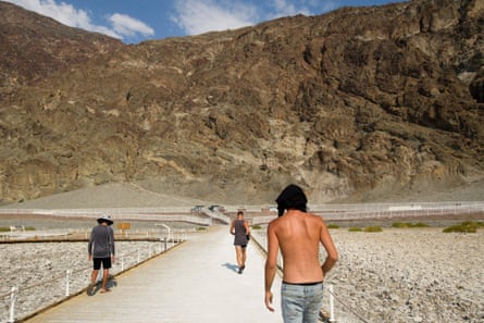 Visitors walk by the salt flats of Badwater Basin inside Death Valley national park.