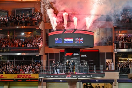 Max Verstappen, Oscar Piastri and Lando Norris on the podium at Yas Marina Circuit.