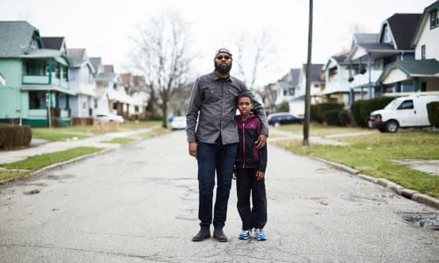 Jamal Collins at the end the street he grew up on in East Cleveland, with his 10-year-old son.