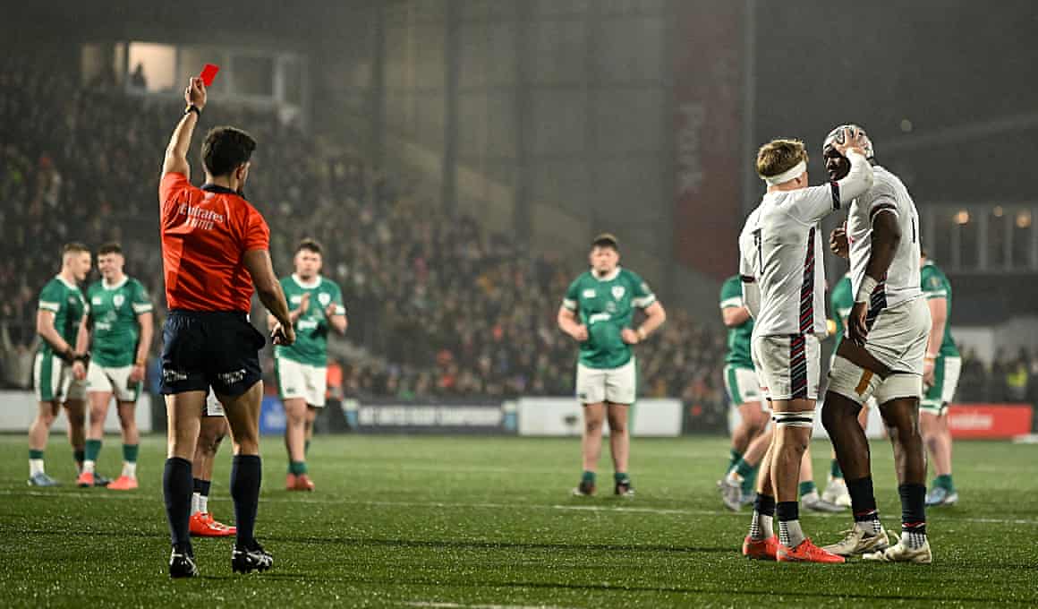 Junior Kpoku of England (right) is consoled by teammate Henry Pollock as he is shown a red card by referee Jérémy Rozier in the U20 Six Nations