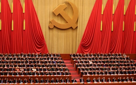 Delegates raise their hands as they vote during the closing ceremony of the Communist party congress in Beijing