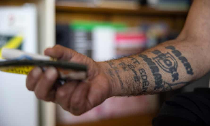 Rangi Wickliffe’s arm, which shows tattoos memorialising his time in Paremoremo prison’s D Block, the harshest wing of the maximum security prison, and Mt Eden, a Victorian era prison in Auckland.